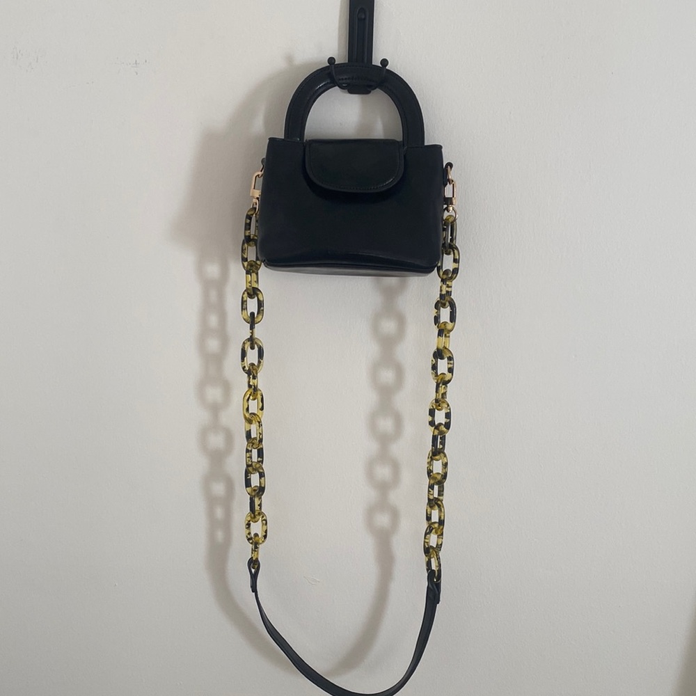 H.O.W. Mini bag with recoverable tortoise links shoulder strap.